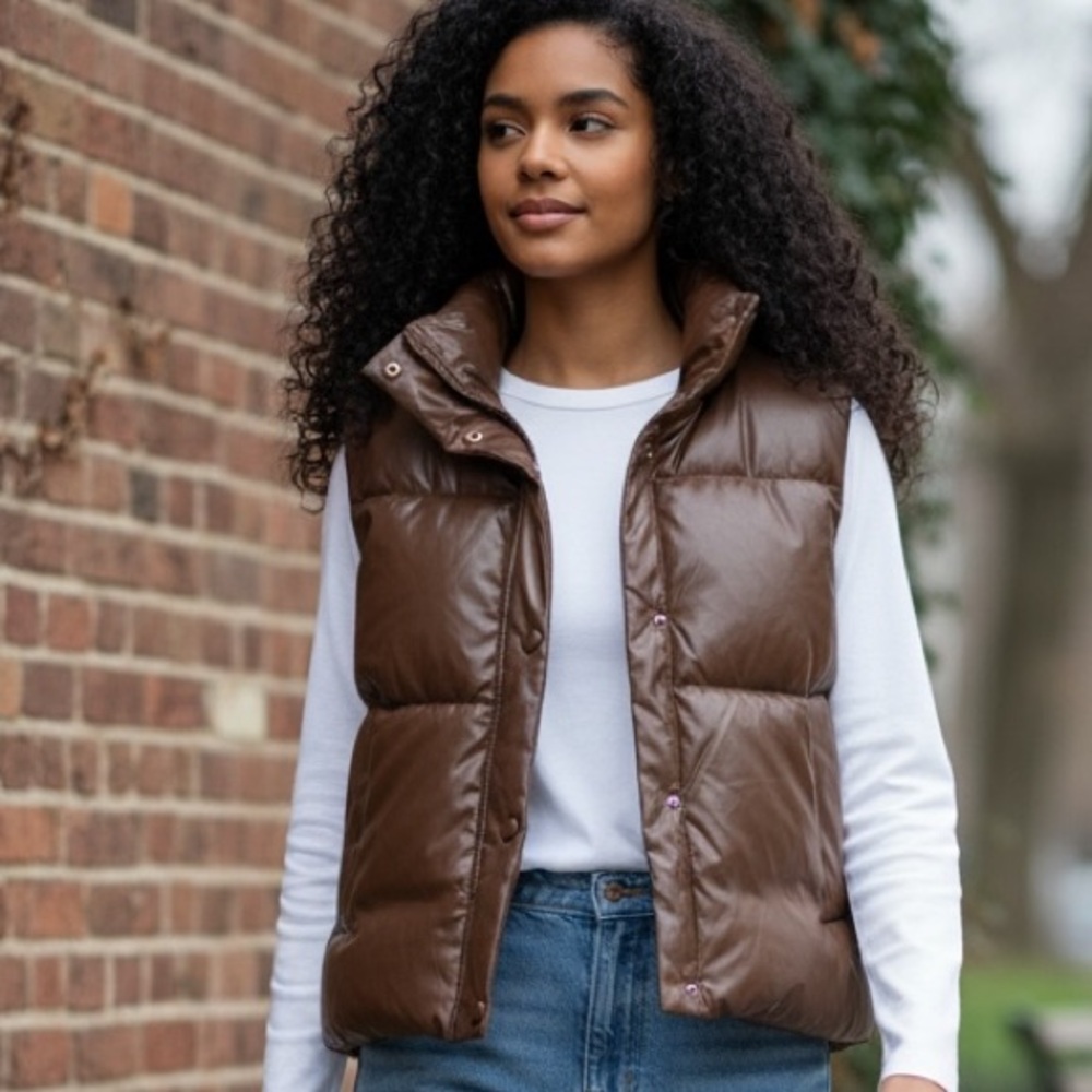 Puffy Brown Zipper jacket that is sleeveless.